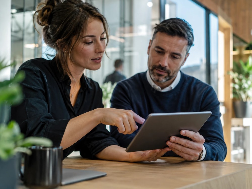 Two colleagues reviewing an app together